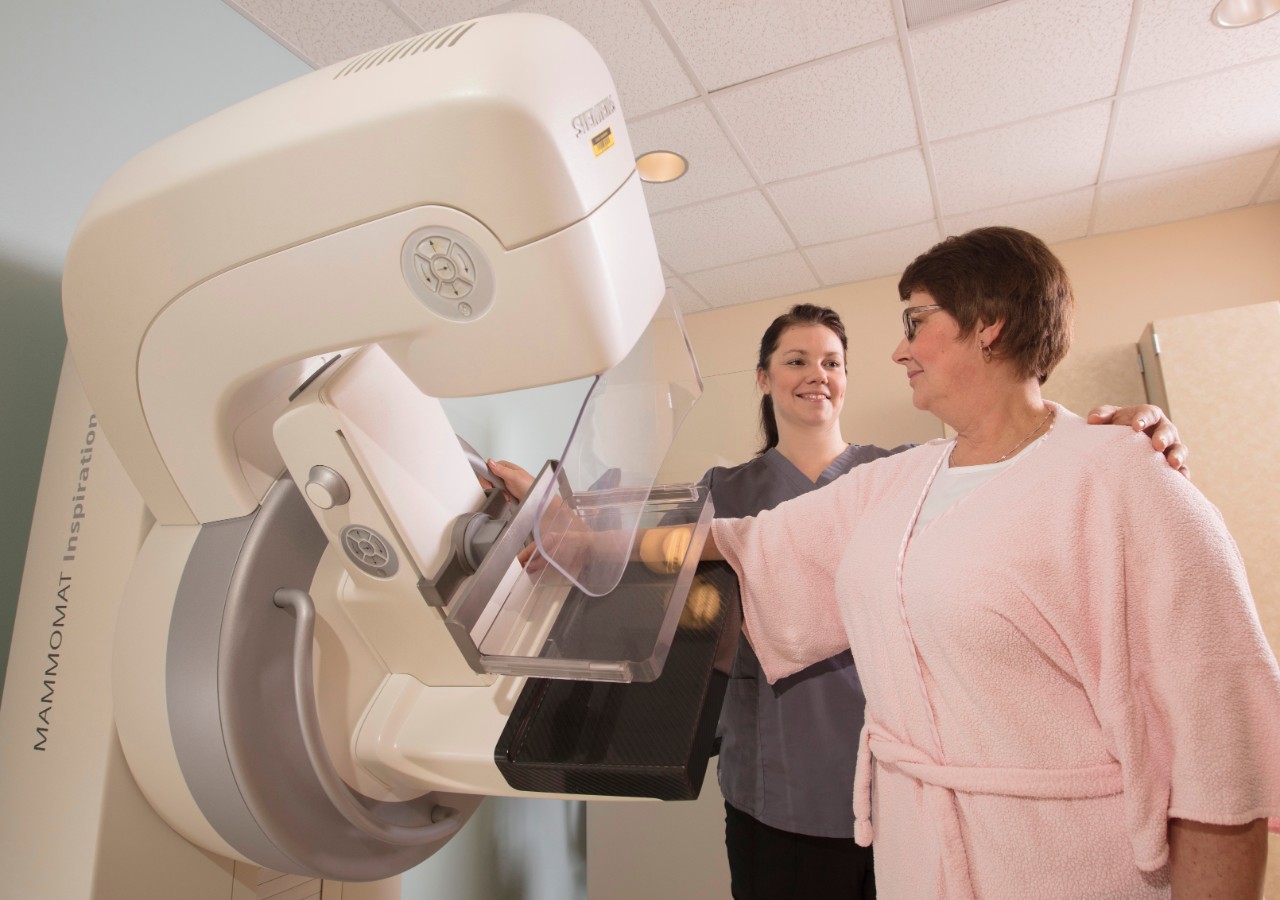 Female technician preping female patient for a 3D mammography - Have your mammography done at CHI St. Francis with the latest 3D technology